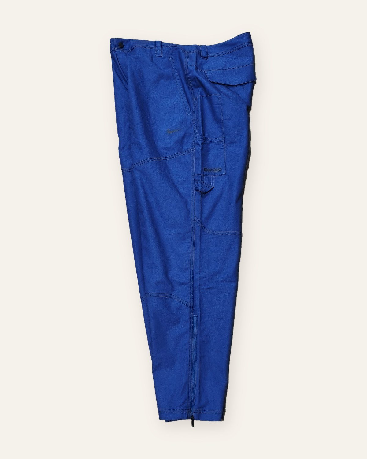 Nike x NOCTA x L'Art pants – side view with cargo pocket and zipped hem