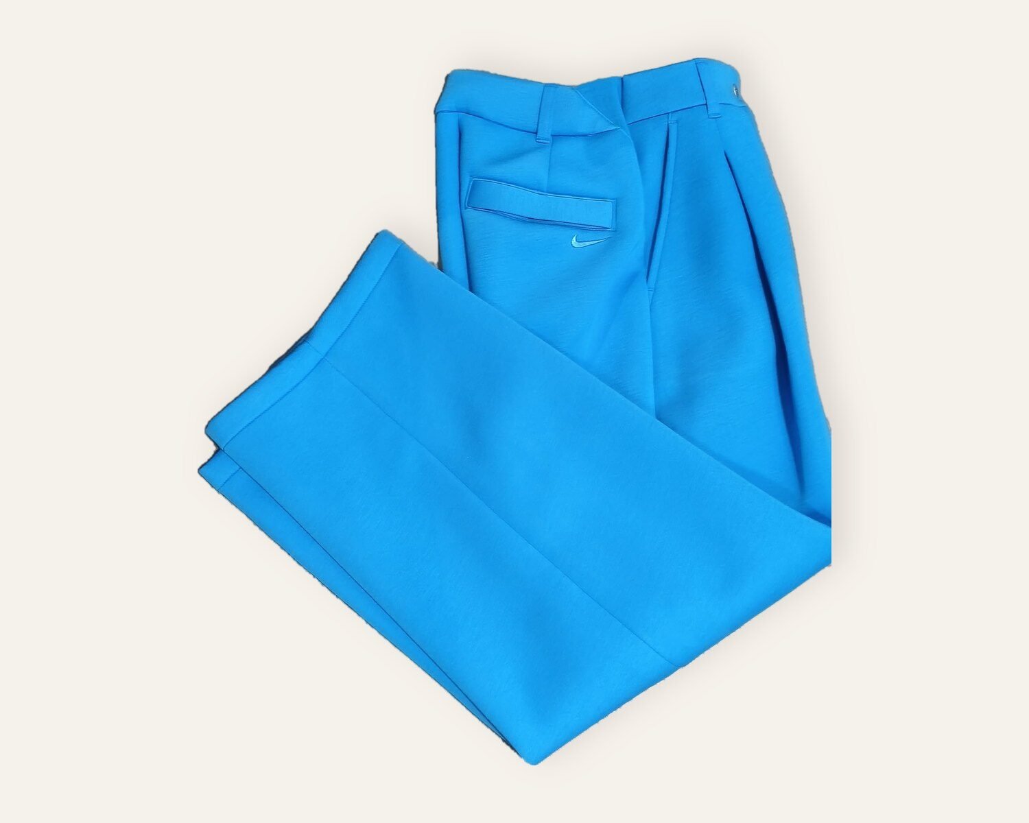 Nike blue fleece trousers folded – pleats and back pocket detail